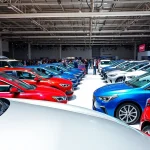 Enthusiasts admiring vehicles at the Auto Cars Show, showcasing automotive innovation and excitement.