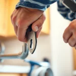 Find a skilled plumber near me fixing a leak with precision in a modern kitchen.